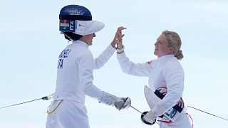 Italy's Elena Micheli and Britain's Kerenza Bryson cheer after competing in the final fencing bonus round in the women's pentathlon at the 2024 Olympics, 11 August 2024