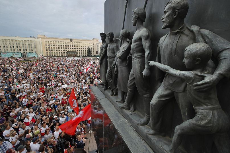 FILE - In this Aug. 18, 2020 file photo Belarusian opposition supporters gather for a protest rally in front of the government building at Independent Square in Minsk, Belarus