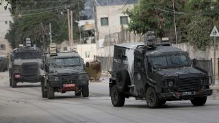 Israeli armoured vehicles move on a street during a military operation in the West Bank city of Jenin