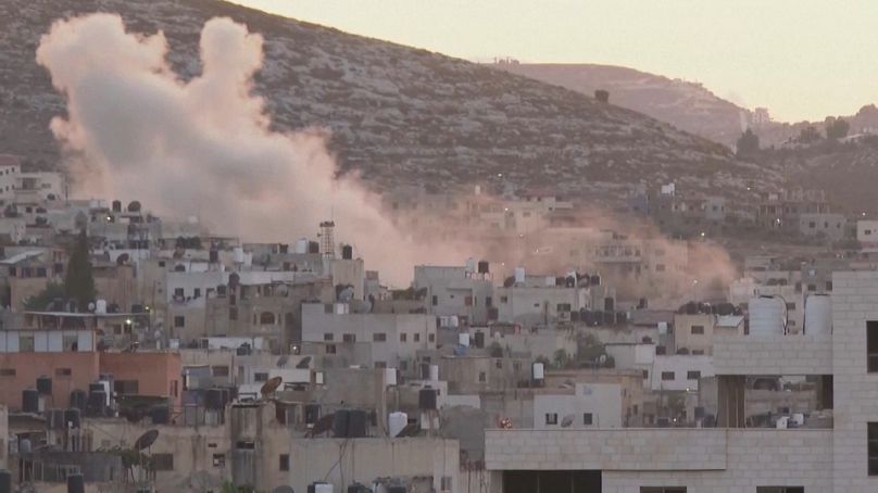 Smoke rises above the West Bank as Israel continues its military operation.