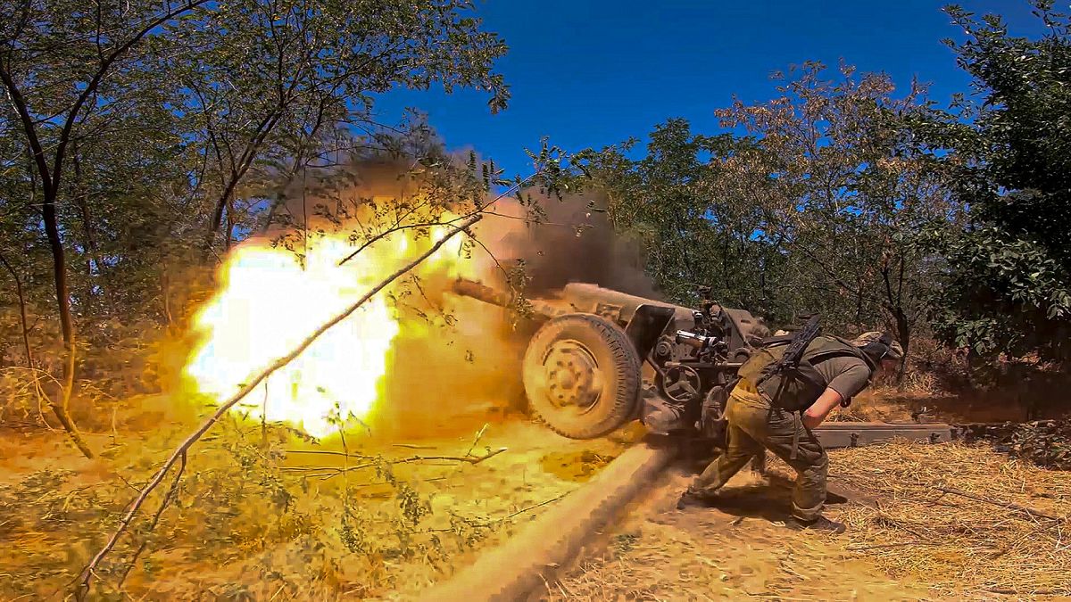 Russian soldier fires towards Ukrainian positions at an undisclosed location in Ukraine