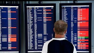 Um passageiro olha para os ecrãs de informação que mostram os voos cancelados no aeroporto de Arlanda, nos arredores de Estocolmo