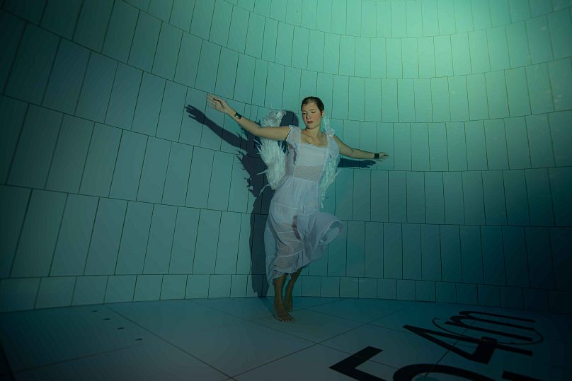 Freediver Christin Gerstorfer poses with wings at 45,4 metres underwater. Wings in the Deep. 24 August, 2024. Warsaw, Poland.