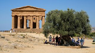 Visitors admire the ancient Concordia temple in the Valley of the Temples, Agrigento, Sicily, Italy, on Thursday, 18 July 2024.