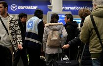 Travelers queue for the Eurostar trains at St Pancras Station in London, 22 December 2023. 