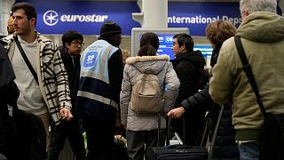 Travelers queue for the Eurostar trains at St Pancras Station in London, 22 December 2023. 