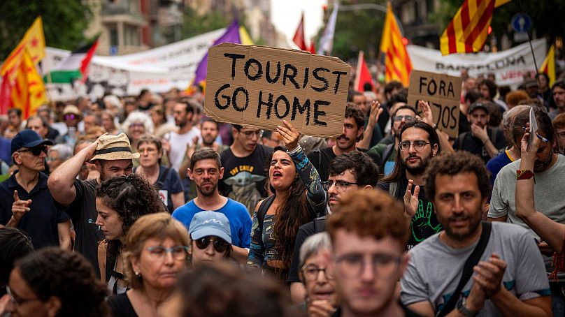 Demonstrators march against overtourism in Barcelona, Spain, 19 June 2024. 