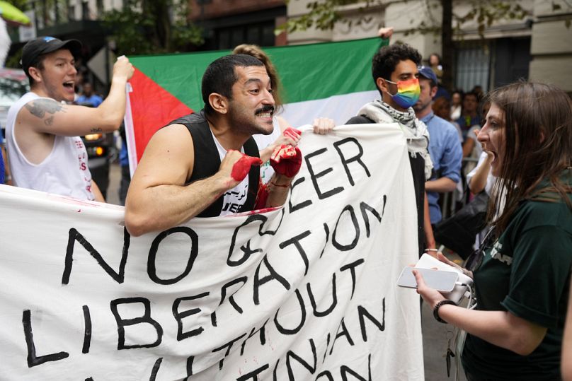 A pro-Palestinian protestor argues with parade staff while blocking the parade route during the NYC Pride March in New York, June 2024