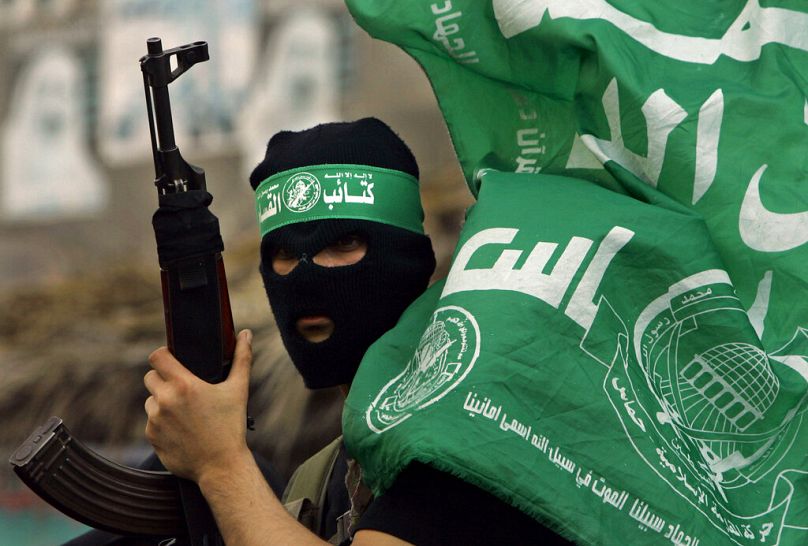 A masked miltant from Hamas carries his weapon during a rally by the group in the Shati Refugee Camp, April 2007