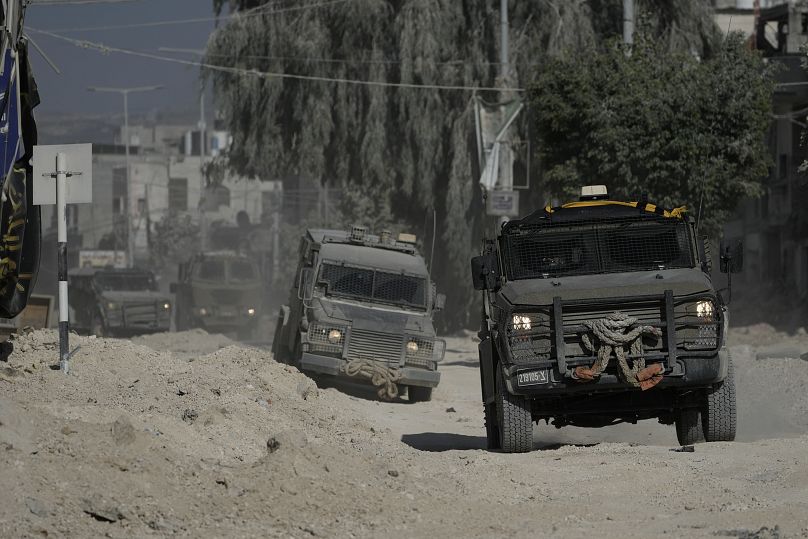 Israeli armoured vehicles move on a street in the West Bank refugee camp of Nur Shams, Tulkarem.