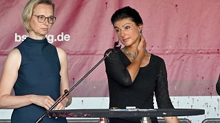 Sahra Wagenknecht, right, chairwoman of the BSW, stands on stage after an attack with red paint at the election campaign event on Domplatz, Erfurt, 30 August 2024