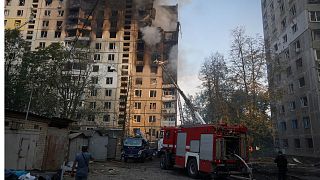 Firefighters put out the fire after the Russia's guided air bomb hit an apartment building in Kharkiv.