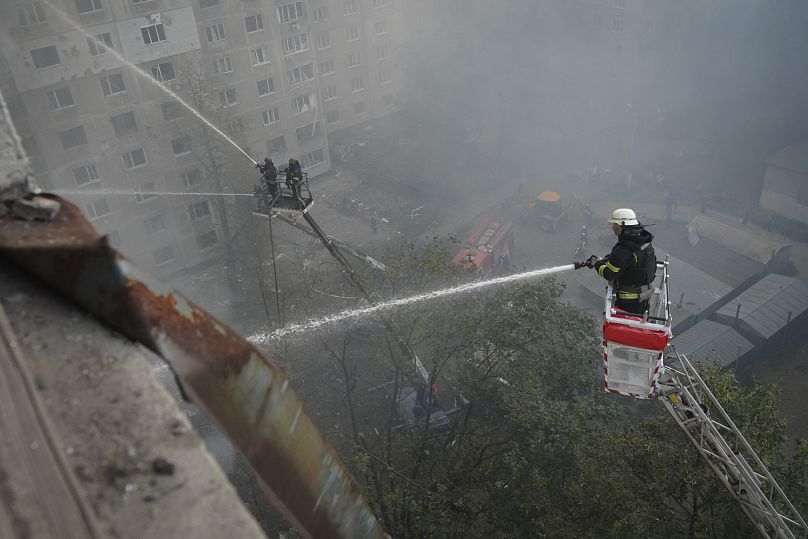 Firefighters put out the fire after the Russia's guided air bomb hit an apartment building in Kharkiv, August 30, 2024