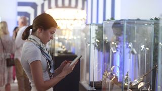 A female watch enthusiast enjoying the new timepieces in the Geneva Watch Days pavilion