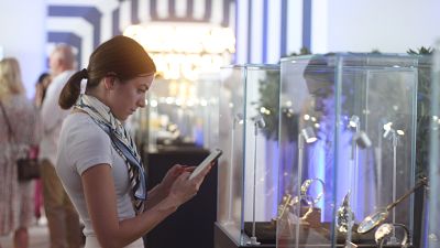 A female watch enthusiast enjoying the new timepieces in the Geneva Watch Days pavilion