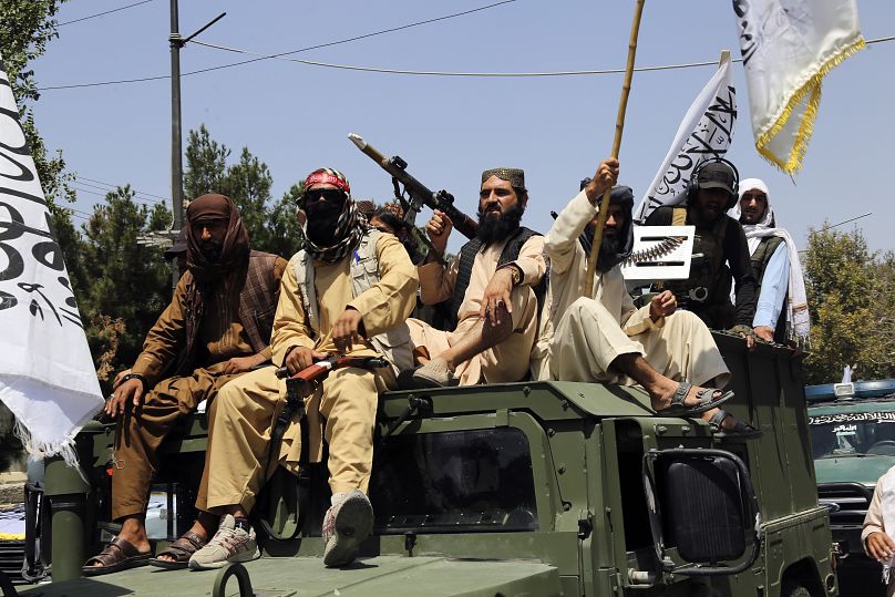 Taliban fighters celebrate the third anniversary of the withdrawal of US-led troops from Afghanistan, August 14, 2024