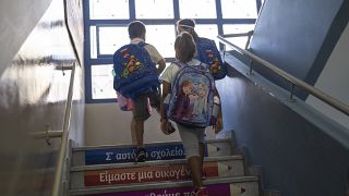 Students walk upstairs to enter class on their first day of school in Piraeus, September 12, 2022