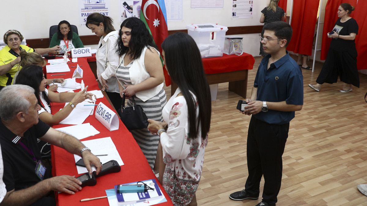 Voters lineup to collect their ballots at a polling station during a snap election in the Milli Mejlis parliament in Baku, Azerbaijan, Sunday, Sept. 1, 2024.