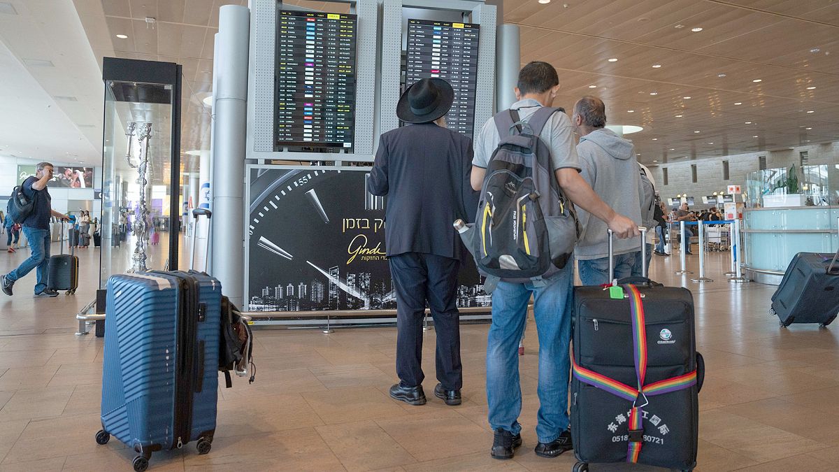 Travelers check departing flights at Ben Gurion International Airport near Tel Aviv, 2 September 2024