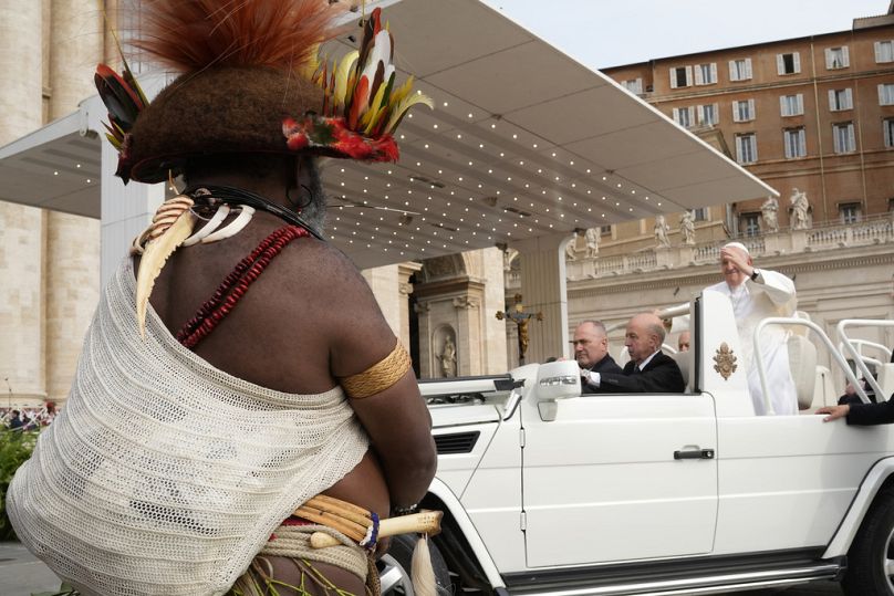 Pope Francis waves Chief of the Huli tribe in Papua New-Guinea, Mundiya Kepanga, as he arrives for his weekly general audience in St. Peter's Square, at the Vatican, Wednesday