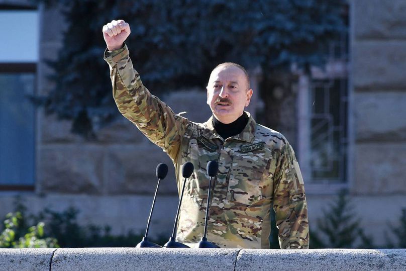 In this photo provided by the Azerbaijan's Presidential Press Office, Azerbaijani President Ilham Aliyev speaks at a parade in Khankendi, capital of the former breakaway..