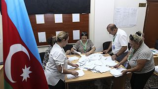 Members of an election commission count ballots at a polling station after a snap election in the Milli Mejlis parliament in Baku, Azerbaijan, Sept. 1, 2024