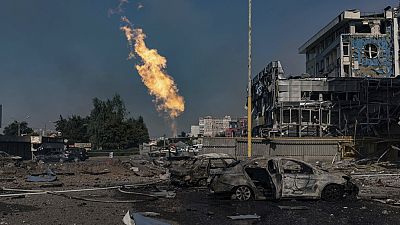 Gas burns in front of a business center damaged by a Russian attack in Kharkiv, Ukraine, Sunday, Sept. 1 2024.