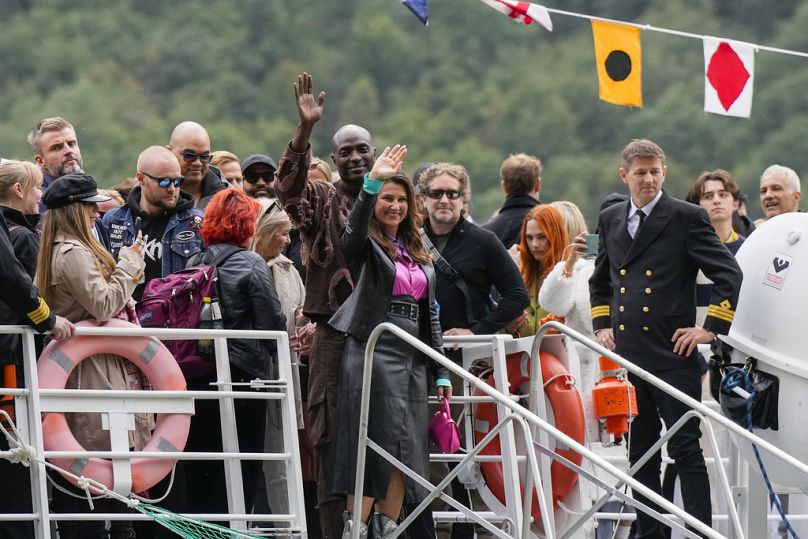 Norway's Princess Martha Louise, center, and Durek Verret, rear center, and guests arrive from Alesund to Geiranger, Norway, Friday Aug. 30, 2024.