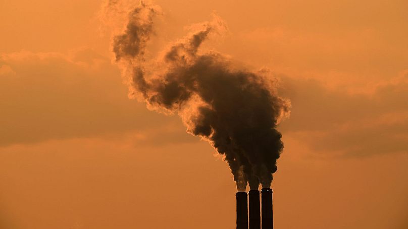 Smokestacks at the Jeffrey Energy Center coal-fired power plant are silhouetted against the sky at sunset 12 September 2020, near Emmet, Kansas.