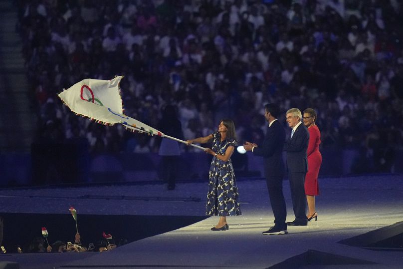 Paris Belediye Başkanı Anne Hidalgo, 11 Ağustos 2024 Pazar günü Fransa'nın Saint-Denis kentindeki Stade de France'da düzenlenen 2024 Yaz Olimpiyatları kapanış töreninde Olimpiyat bayrağını sallıyor.