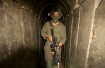 Israeli soldiers escort the media to an underground tunnel found underneath Shifa Hospital in Gaza City,