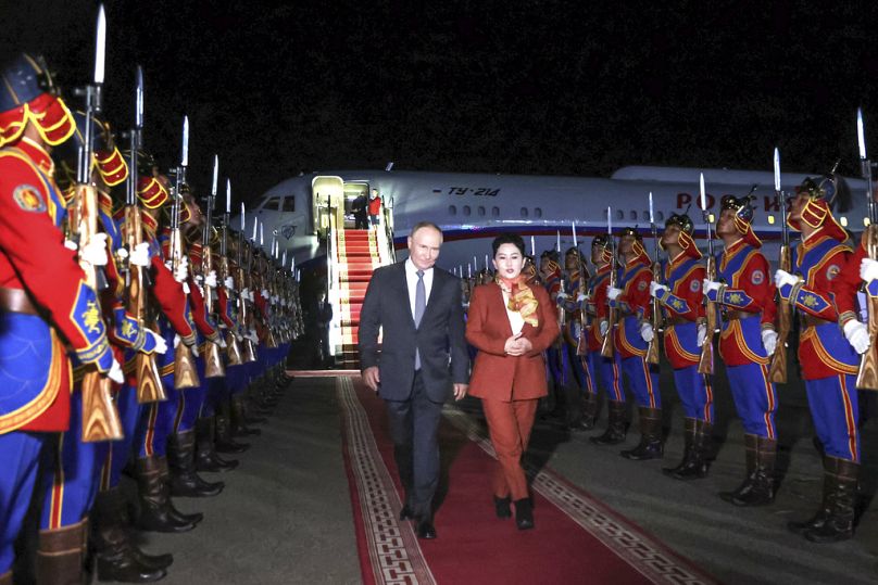 Russian President Vladimir Putin, on red carpet left, walks next to Mongolian Foreign Minister of Mongolia, Batmunkh Battsetseg upon his arrival in Mongolia.