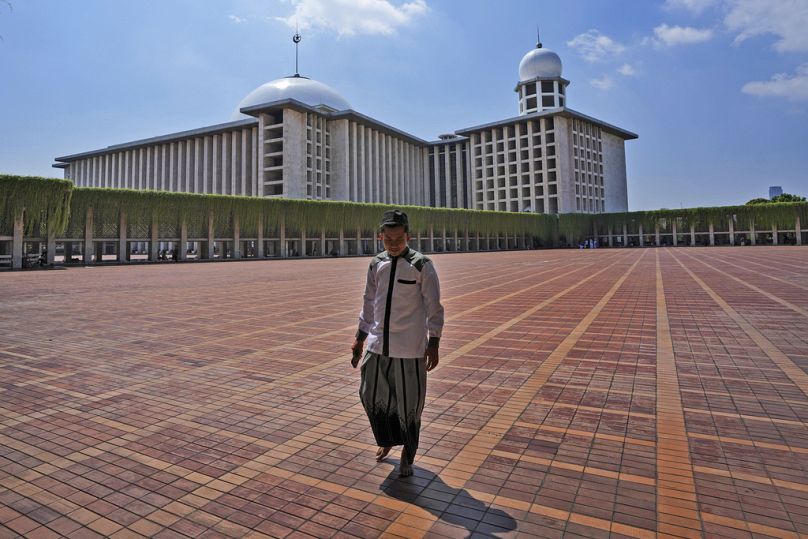 A man walks at Istiqlal Mosque after Friday prayers in Jakarta, Indonesia, Friday, Aug. 9, 2024.