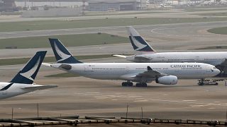 In this March 26, 2019 photo, Cathay Pacific Airways passenger aircrafts are parked at the Hong Kong International Airport. 