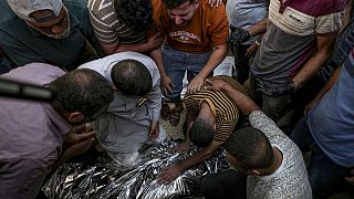 Palestinians mourn a relative killed in the Israeli bombardment of the Gaza Strip at a hospital morgue in Deir al-Balah, Sunday, Sept. 1, 2024.