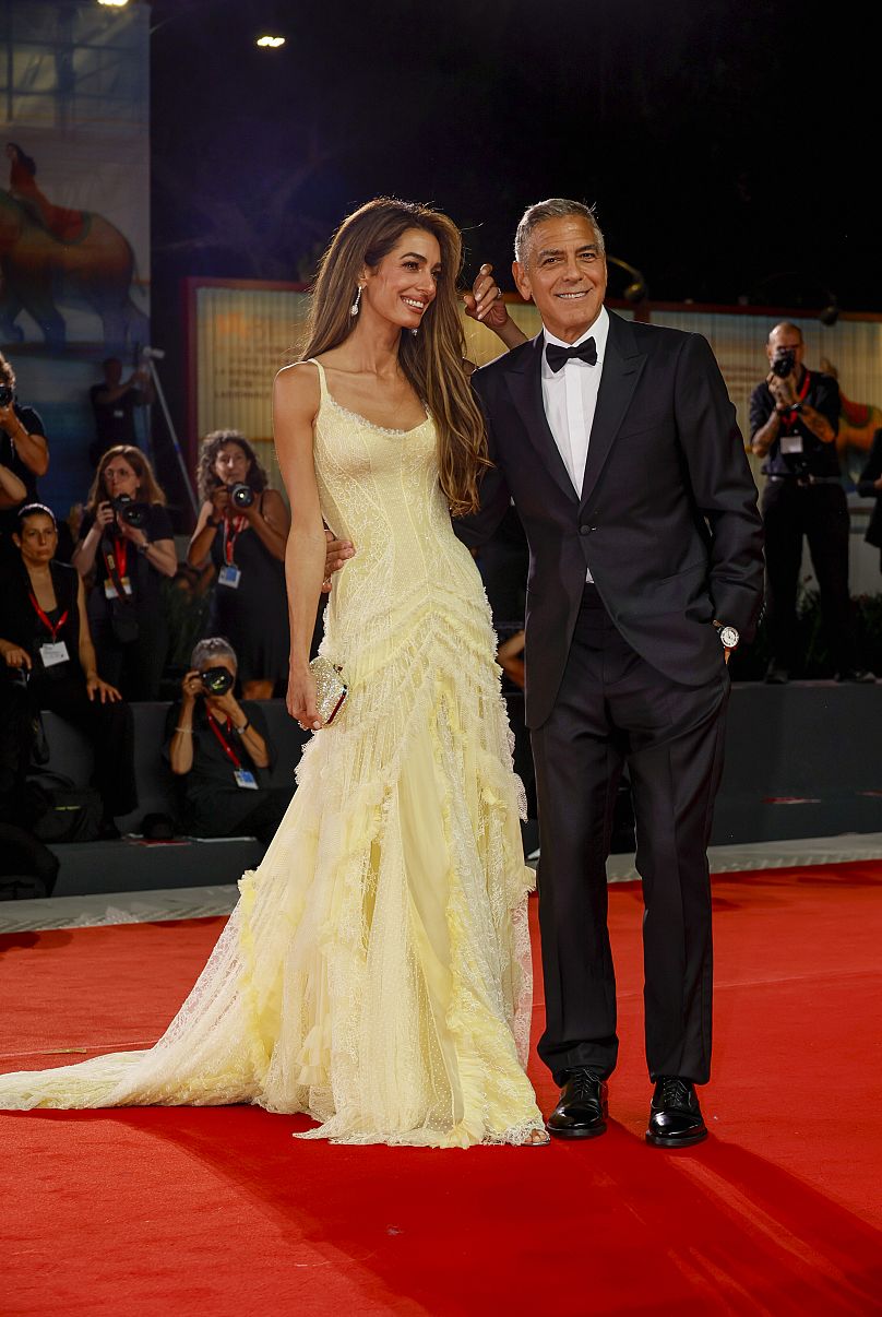 Amal Clooney and George Clooney attend the “Wolfs” red carpet during the 81st Venice International Film Festival.