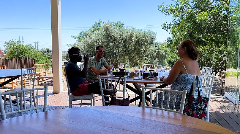Tourists enjoy a wine tasting at Quinta do Canhoto