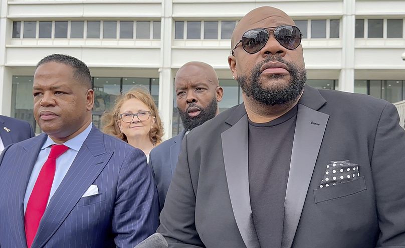 Isaac Hayes III, right, and his attorney address reporters outside a federal courthouse in Atlanta, Tuesday,3  September  2024. 