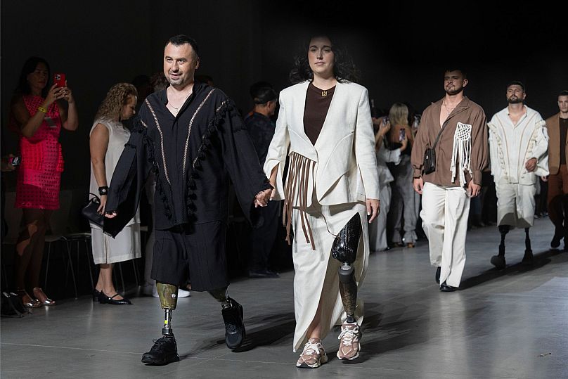 Ukrainian war veterans wearing prosthetics takes to the runway to demonstrate outfit by designers Andreas Moskin and Andriy Bilous during Fashion Week show in Kyiv