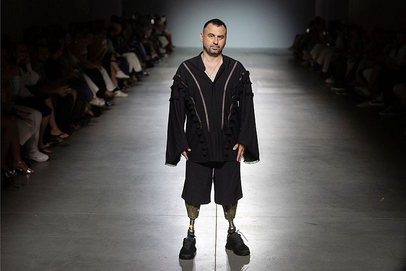 A Ukrainian war veteran wearing prosthetics takes to the runway to demonstrate outfit by designers Andreas Moskin and Andriy Bilous during Ukrainian Fashion Week 