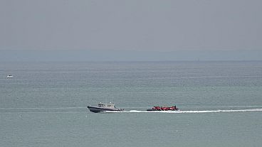 Un'imbarcazione con a bordo dei migranti viene scortata da una nave della Gendarmeria nazionale francese al largo della spiaggia di Wimereux, Francia, 4 settembre 2024