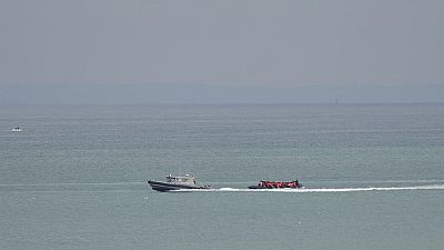 A boat thought to be with migrants is escorted by a vessel from the French Gendarmerie Nationale off the Wimereux beach, France