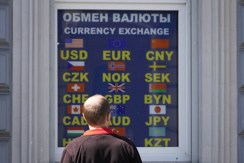 A man stands at a currency exchange office in St. Petersburg, Russia, Thursday, June 13, 2024. 