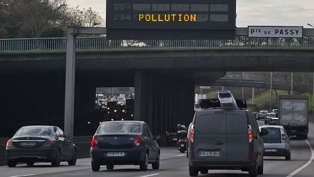 Vehicles drive near Paris during a pollution spike.