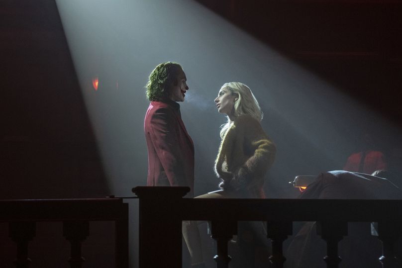 Joaquin Phoenix, left, and Lady Gaga in a scene from 'Joker: Folie à Deux.'