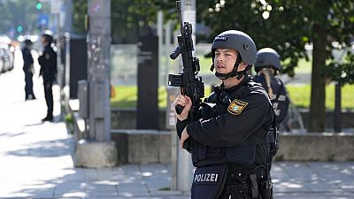 Police officers patrol near a scene after police fired shots at a suspicious person near the Israeli Consulate and a museum on the city's Nazi-era history in Munich, Germany