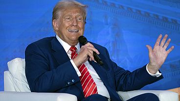 Former President Donald Trump speaks with Moms for Liberty co-founder Tiffany Justice during an event at the group's annual convention in Washington, Friday, Aug. 30, 2024.