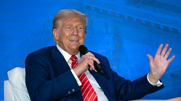 Former President Donald Trump speaks with Moms for Liberty co-founder Tiffany Justice during an event at the group's annual convention in Washington, Friday, Aug. 30, 2024.