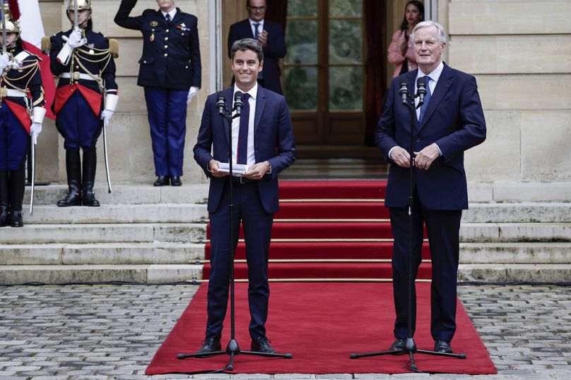 New French prime minister Michel Barnier, right, and outgoing prime minister Gabriel Attal, left, deliver a speech during the handover ceremony in Paris