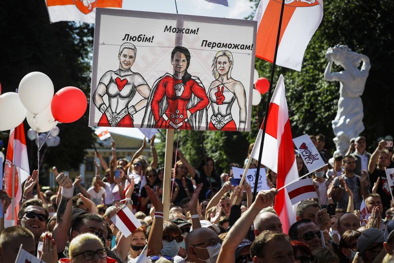 FILE - People hold a banner with portraits of aria Kolesnikova among others in the town of Baranovichi southwest of Minsk, Belarus, on Sunday, Aug. 2, 2020.